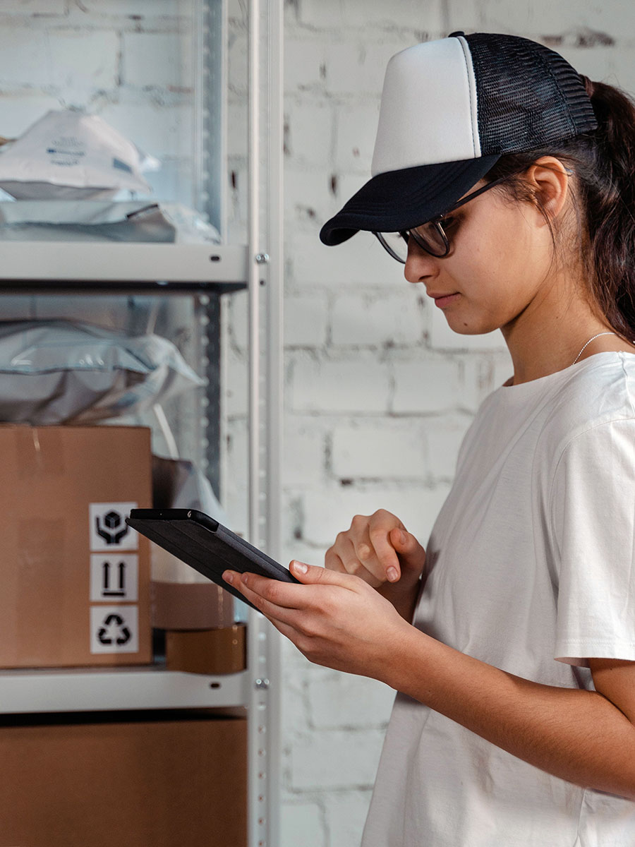 fulfilment worker in warehouse on ipad